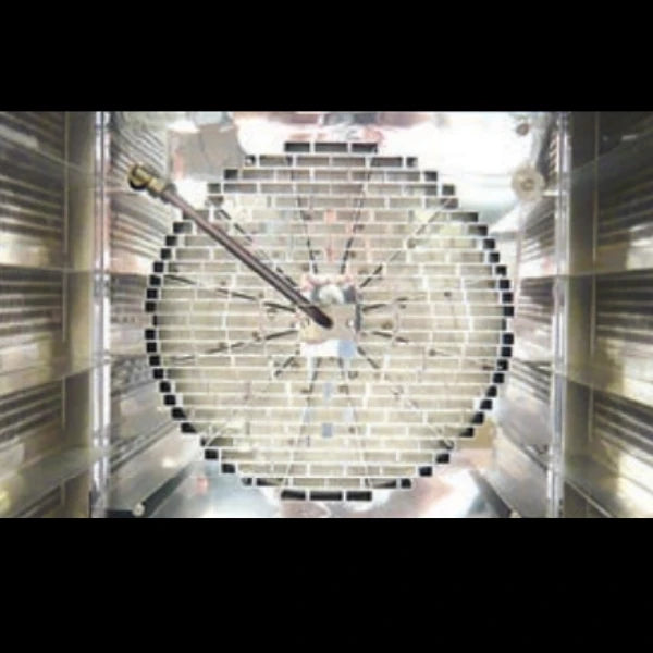An oven fan from a convection oven mounted inside a metallic oven chamber with reflective walls.