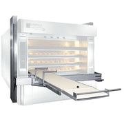 An Empire countertop commercial bread oven with a manual dough loader, shown with loaves of bread inside on a white background.