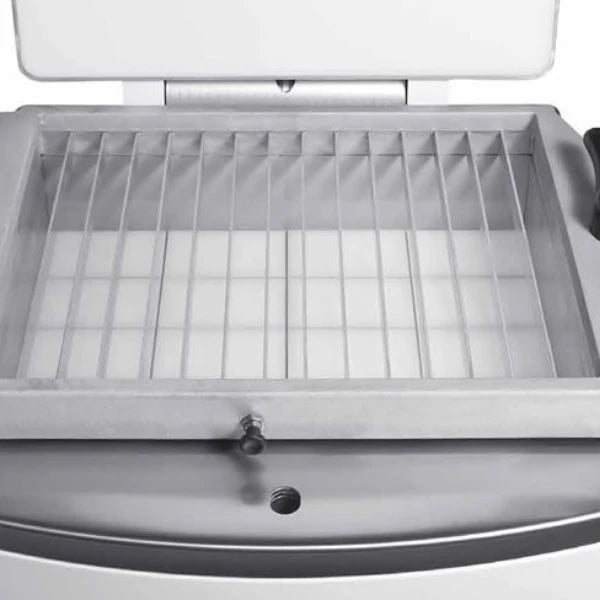 Close-up of a metal dividing grid inside a dough divider machine with the lid open.