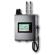A silver industrial electronic water dosing meter with a central color touchscreen display, mounted on a white background. It features two metal pipe connectors on top, a black coiled cable hanging from the side, and a black protective cover over the lower connection points.