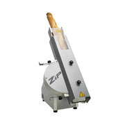 A commercial bread slicing machine with a silver metal body, featuring a loaf of bread in the input slot and the brand name 'Zip' printed on the side, set against a plain white background.