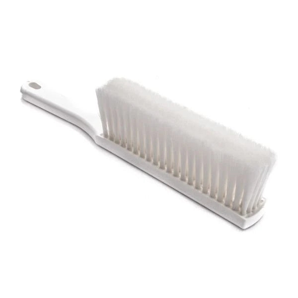 A white plastic counter wiping brush with dense white bristles and a hanging hole at the end of the handle, shown on a plain white background.
