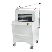 A white commercial bread slicer machine mounted on casters, with a long vertical handle, bread bagger attachment, and a small red emergency stop button on the front.