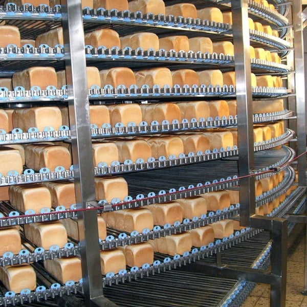 close up view of bread on an industrial ambient cooling conveyor