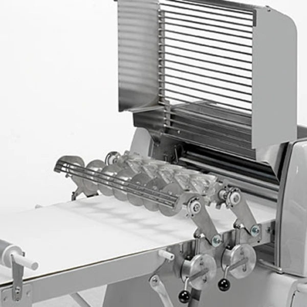 Close up of the croissant cutter attachment for an automated dough sheeter machine.