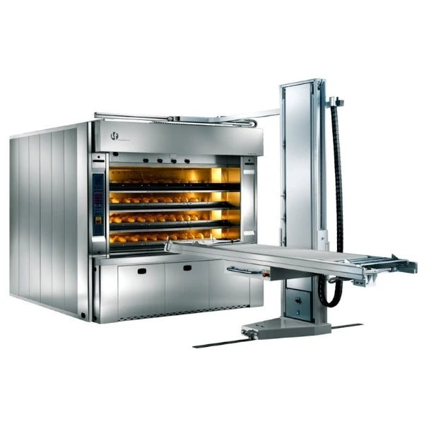 A large commercial bakery oven in stainless steel with multiple shelves of baked goods visible inside, shown on a clean white background. A metal automatic oven loader extends to the right.
