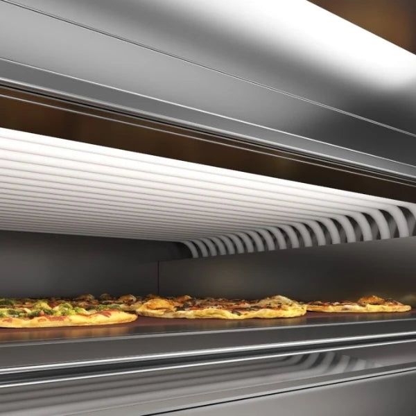 Close-up of a stainless steel pizza oven with several pizzas baking on the lower deck with the steam tube baking system visible. 