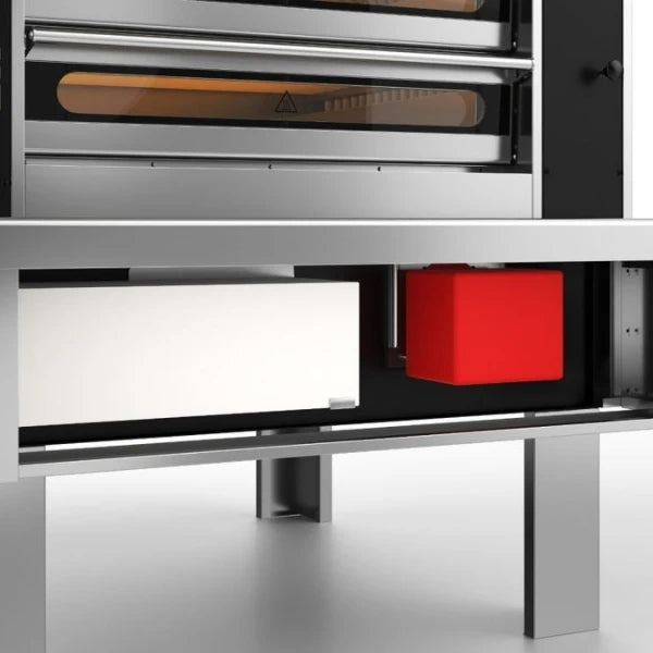 Close-up of a stainless steel commercial pizza oven highlighting the location of the burner system. 