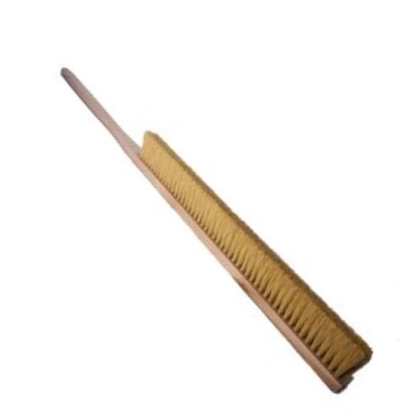 A long-handled oven brush with dense golden-yellow bristles and a light brown wooden handle, shown diagonally on a plain white background.