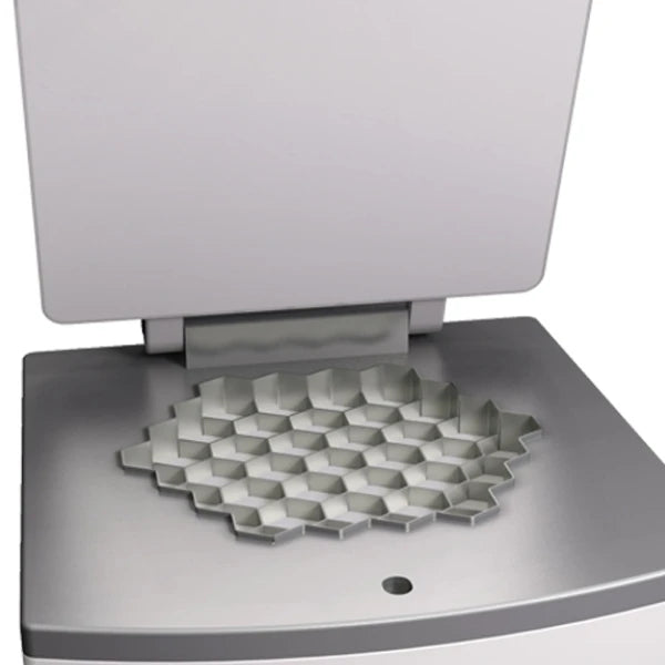 A close-up of a metallic silver dividing plate that shows hexagonal divisions of the machine. 