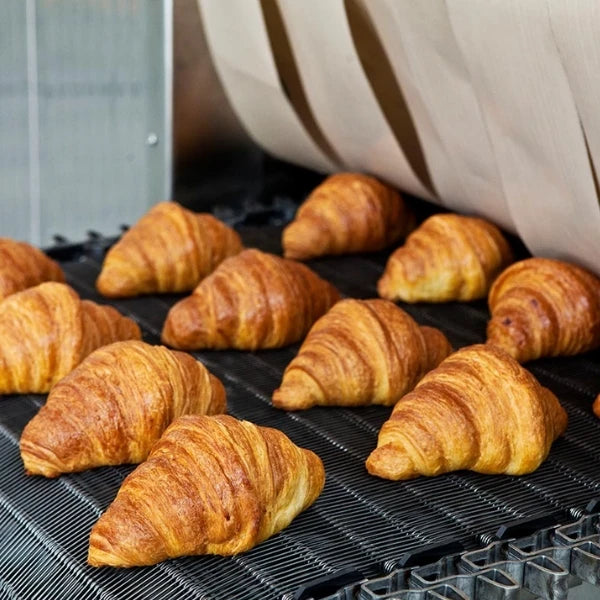 close up of croissants coming out of the spiral thermal oil oven